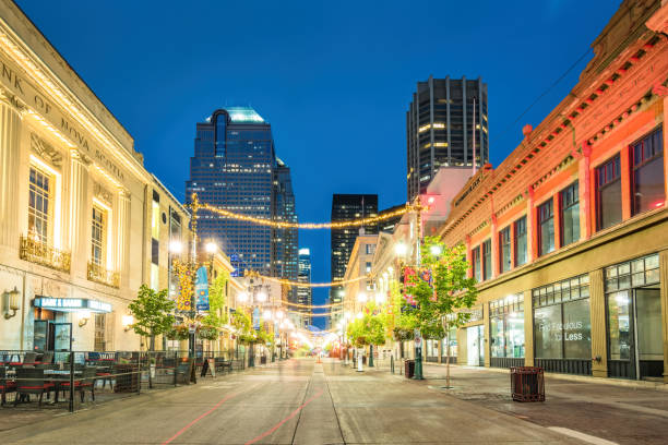 The landmark Stephen Avenue Walk with restaurants and stores in old town Calgary Alberta Canada illuminated at twilight blue hour.