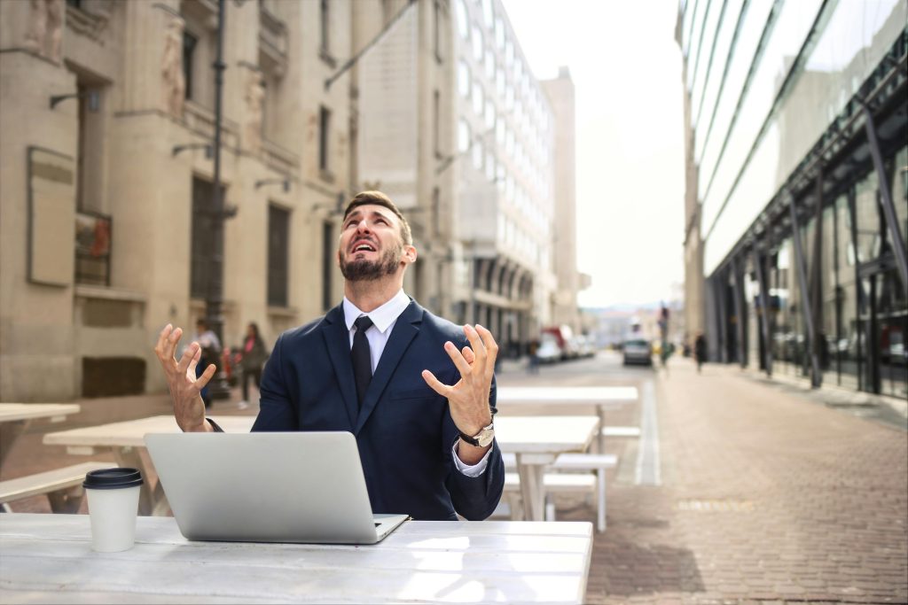 Mna stressed looking at sky in defeat from what he saw on laptop
